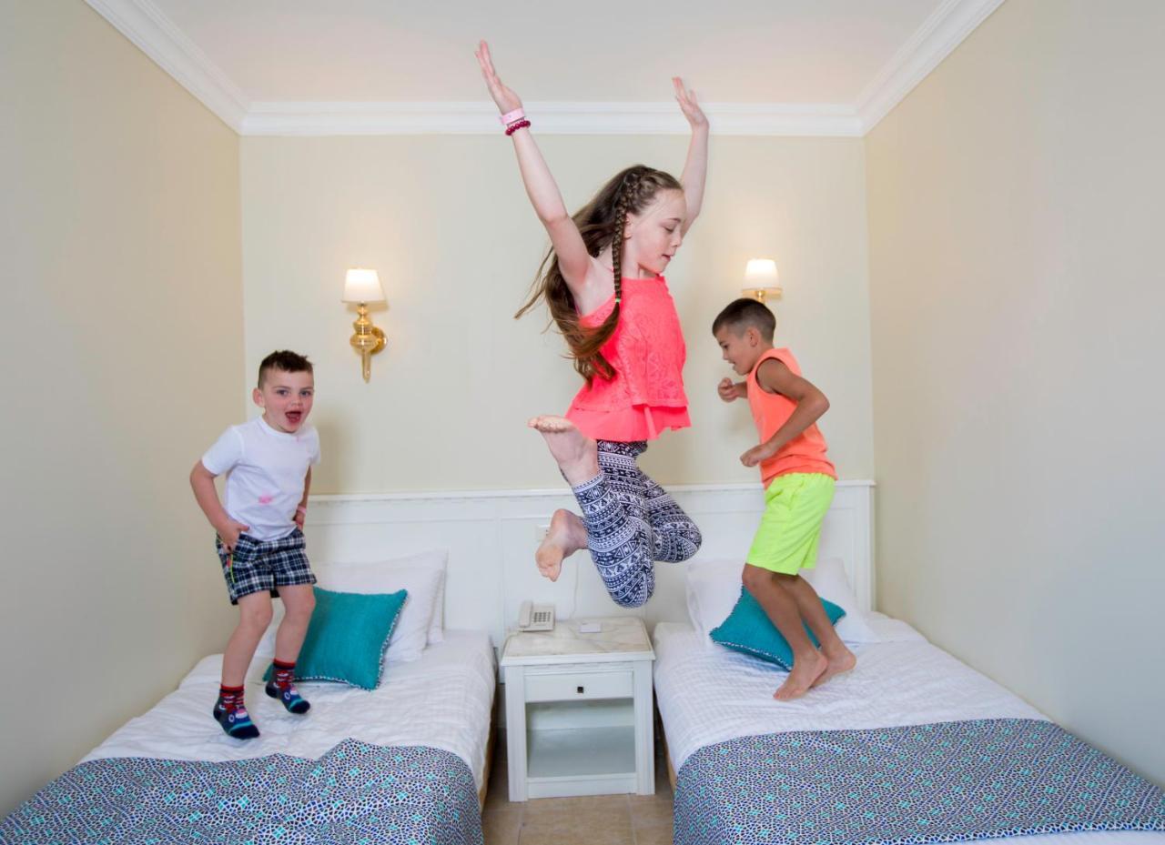 Sunrise Garden Beach Resort Hurghada Exterior photo Children jumping on a bed
